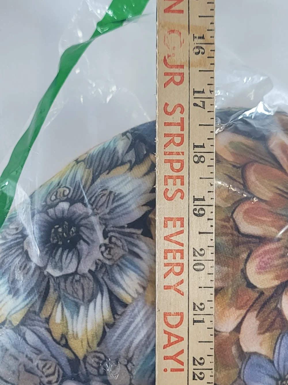 C-shaped nursing pillow featuring a vibrant, bohemian floral pattern